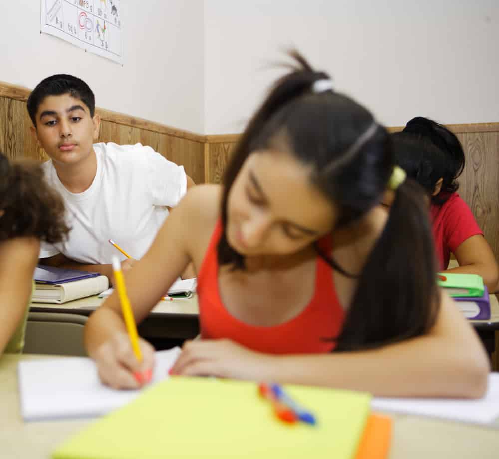 Teacher by her students. Cheating in class. Cheating students.